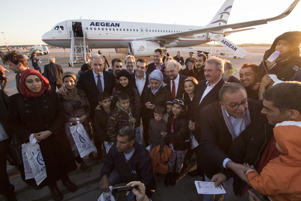 In this photo released by the Greek prime minister’s office on Wednesday, Greece’s Prime Minister Alexis Tsipras (centre) the President of the European Parliament Martin Schulz (centre right) Foreign Minister of Luxembourg Jean Asselborn (2nd right) and European Commissioner for Migration Home Affairs Dimitris Avramopoulos (centre left) pose with refugees at the Athens International Airport (AP photo)